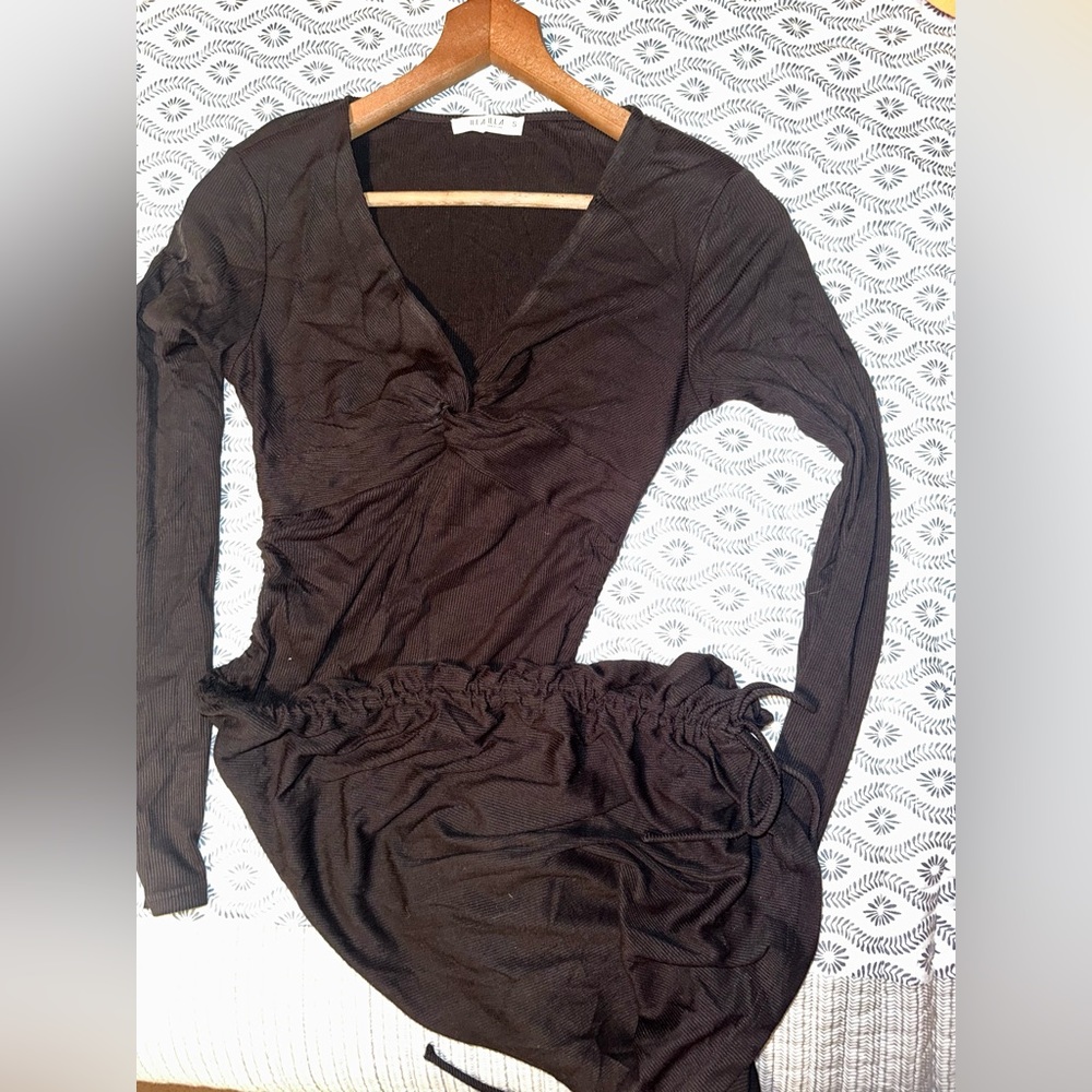 Black long sleeved midi dress with ruched sides and cute styled knot at chest.